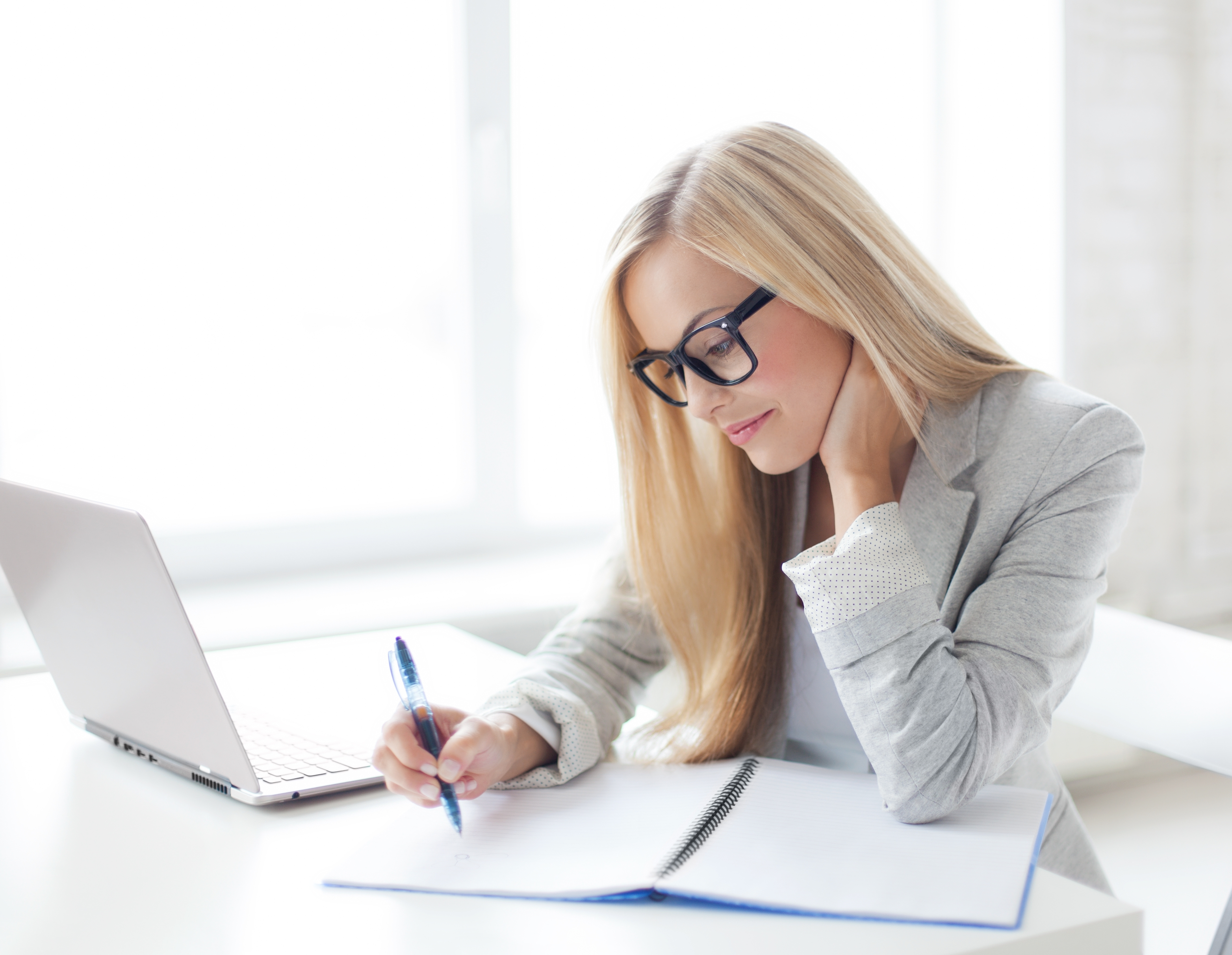 indoor picture of smiling woman with documents and pen